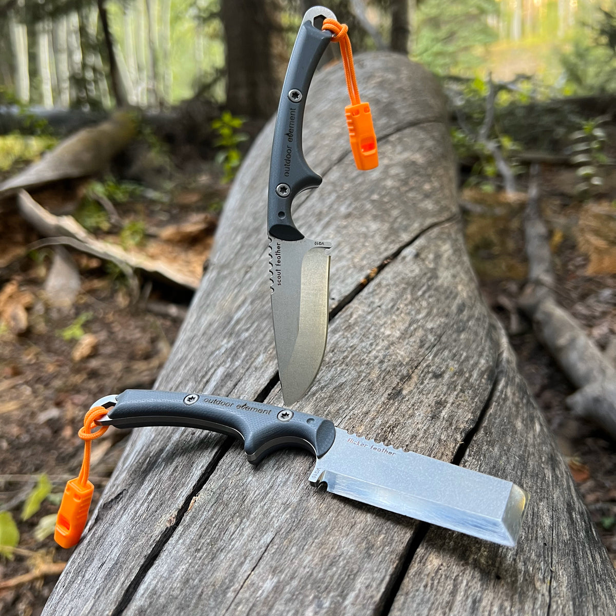Outdoor Element Flicker Feather Chisel Blade and Scout Feather Drop Point Blade on fallen tree
