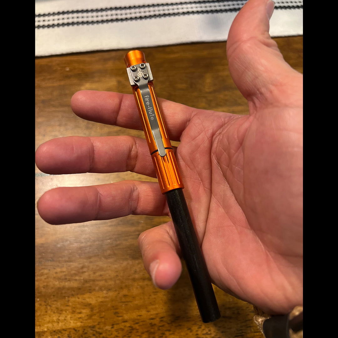 fire flute shown in hand -- roughly the size of a standard Sharpie marker