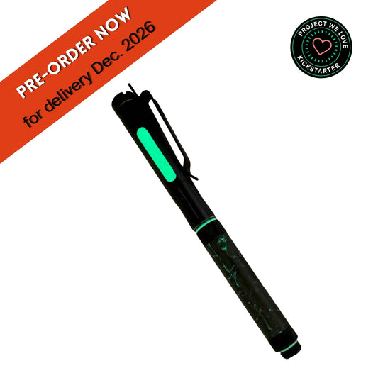 A black multi-tool pen with glowing green accents, shown on a white background with a diagonal orange banner reading 'PRE-ORDER NOW for delivery Dec. 2026' and a circular 'Project We Love Kickstarter' badge.