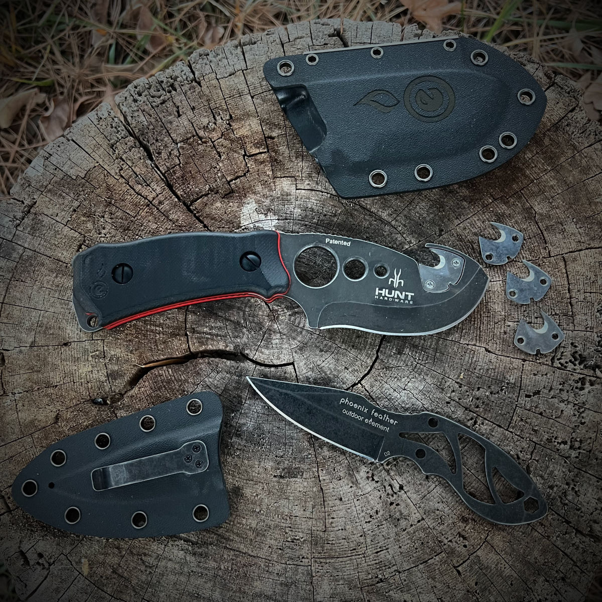 Hunting knives with sheaths on stump