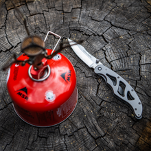 Load image into Gallery viewer, Folding Feather EDC Pocketknife next to camp stove
